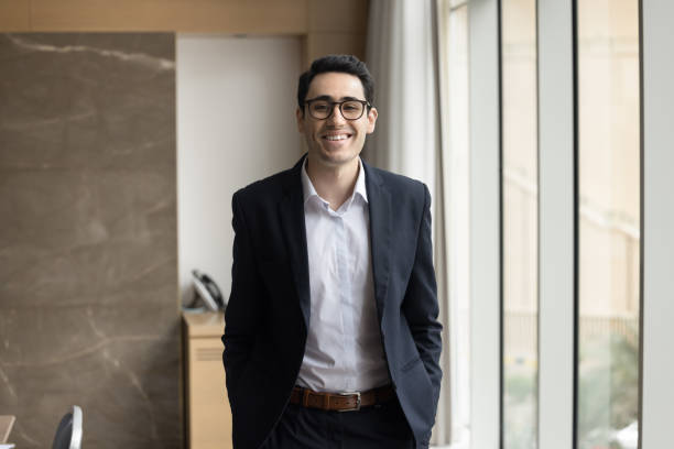 istock Happy young Arab company CEO man standing at workplace 1917808874