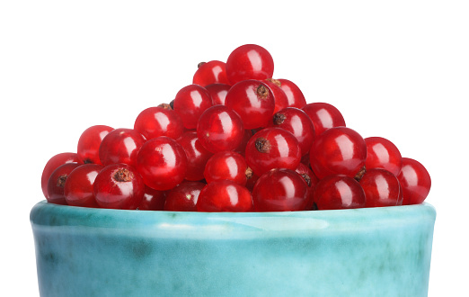 Tasty ripe red currants in bowl isolated on white