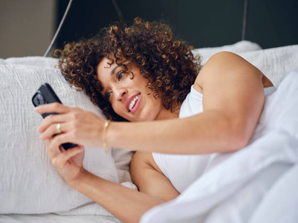istock Woman in Bed in the Morning Using a Smartphone 1917862394