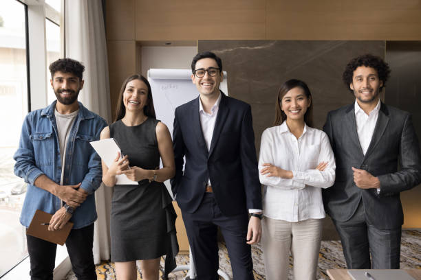 istock Multiethnic team of cheerful successful young managers smiling at camera 1917878258