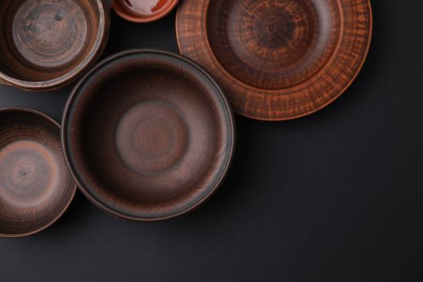 istock Bowls and plates on black background, flat lay. Space for text 1917886692