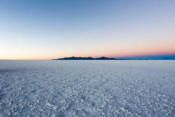 A landscape of Uyuni saltflat at sunrise