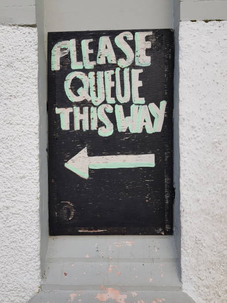 istock Please queue this way information sign, Glasgow Scotland England UK 1917903918