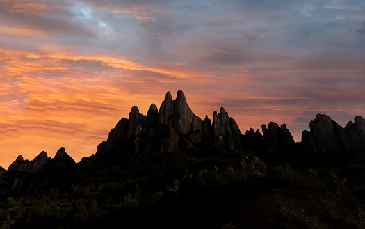 Silhouette of mountains in Montserrat with an colorful evening sky, near Barcelona, Spain.