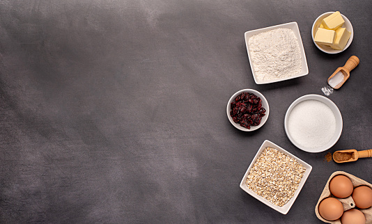 Blank food photography of raw ingredients of oat biscuits, cookie, dough, egg, sugar, white flour, butter, dried cranberry, vanilla, bake, bakery