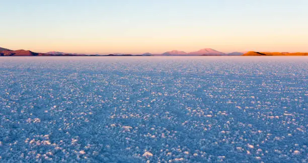 A landscape of Uyuni saltflat at sunrise