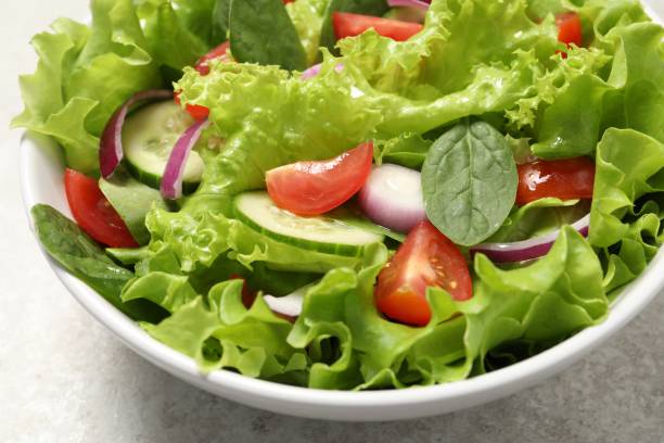 istock Delicious salad in bowl on light grey table, closeup 1917933134