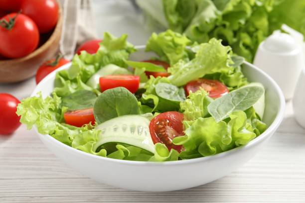 istock Delicious vegetable salad on white wooden table, closeup 1917933135