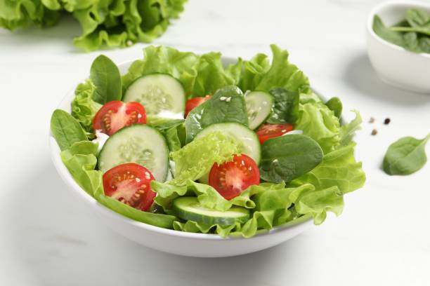 istock Delicious salad in bowl on white table, closeup 1917933663