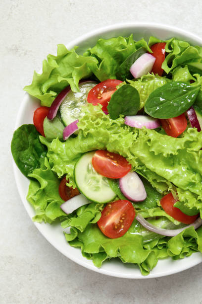istock Delicious salad in bowl on light grey table, top view 1917936783