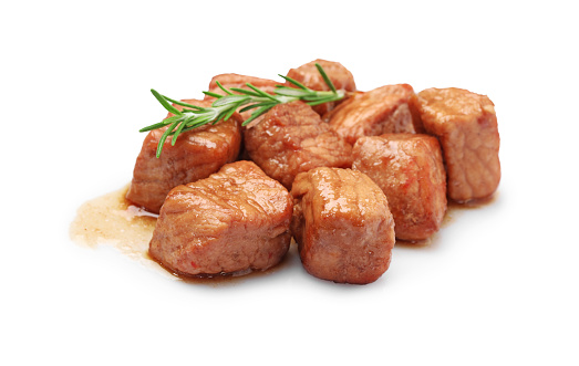 Pieces of delicious cooked beef and rosemary isolated on white. Tasty goulash