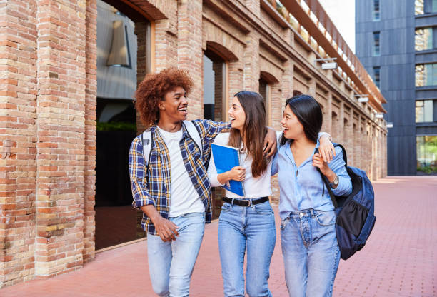 istock Young multiethnic students enjoying their time together talking and laughing while walking around the campus. 1917962331