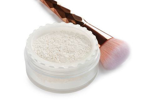 Rice loose face powder and makeup brush on white background