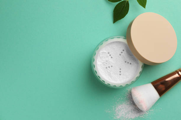 istock Flat lay composition with rice loose face powder and makeup brush on turquoise background. Space for text 1918017283