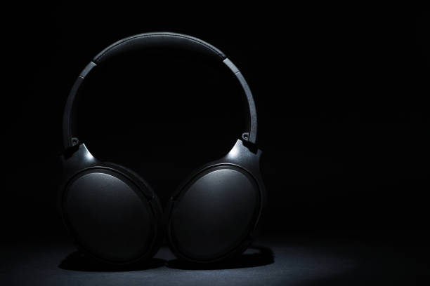 istock Modern wireless headphones on black background, space for text 1918025578