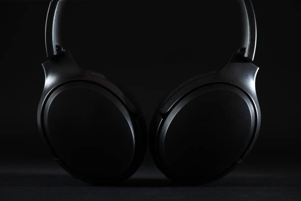 istock Modern wireless headphones on black background, closeup 1918026088
