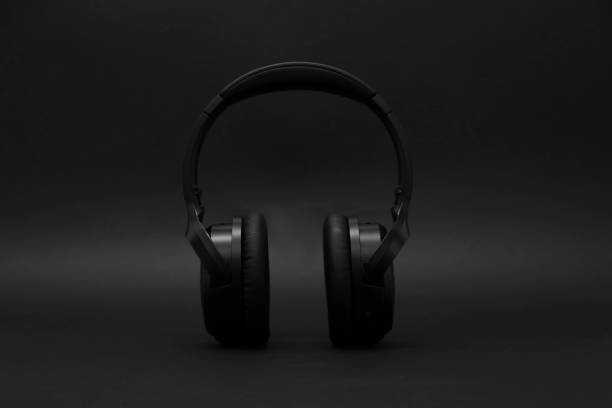 istock Stylish modern wireless headphones on dark background 1918027690