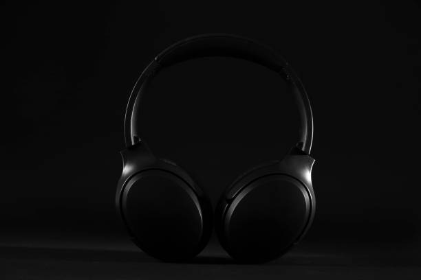 istock Stylish modern wireless headphones on black background 1918027691