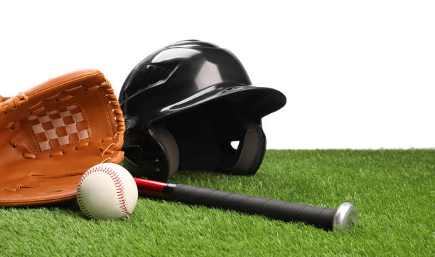 Baseball bat, ball, batting helmet and glove on artificial grass against white background Baseball bat, ball, batting helmet and glove on artificial grass against white background baseball helmet stock pictures, royalty-free photos & images