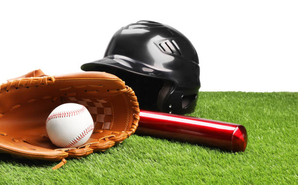 istock Baseball bat, ball, batting helmet and glove on artificial grass against white background 1918054844