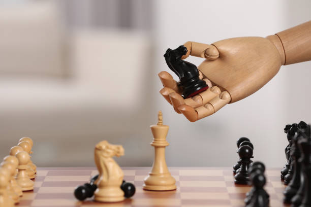 istock Wooden hand representing artificial intelligence. Robot with knight over chessboard against light background, closeup. Space for text 1918071577
