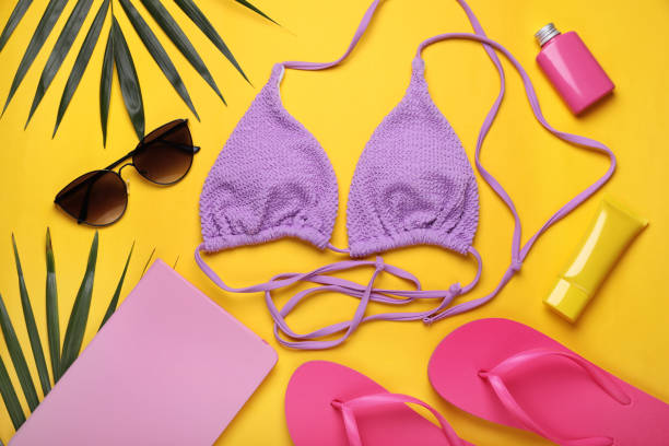 istock Flat lay composition with sunscreen and beach accessories on yellow background 1918072091