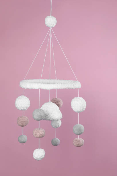 istock Cute baby crib mobile on pink background 1918079494