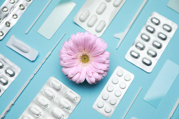 istock Many gynecological pills, tools and gerbera flower on light blue background, flat lay 1918079667