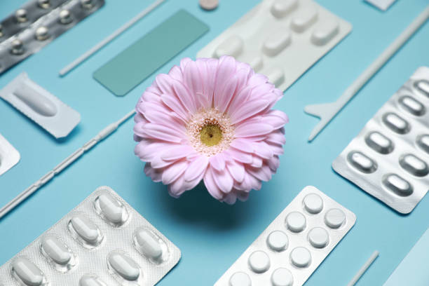 istock Many gynecological pills, tools and gerbera flower on light blue background, closeup 1918080017