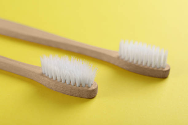 istock Two bamboo toothbrushes on yellow background, closeup 1918081677