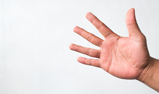 Hand of caucasian young man showing fingers over isolated white background counting number 5 showing five fingers
