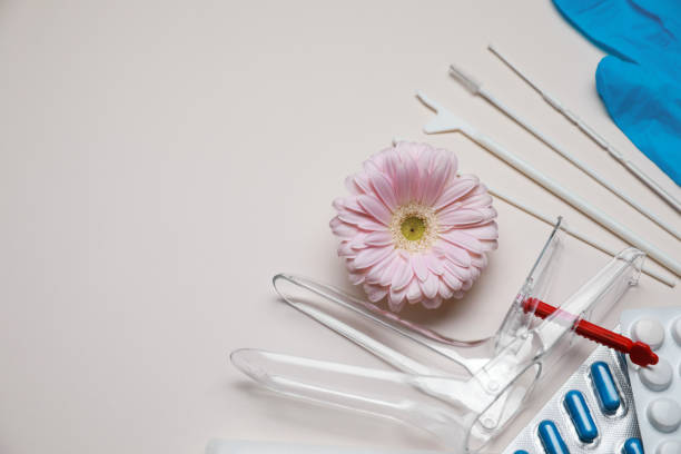 istock Gynecological tools, pills and gerbera flower on beige background, flat lay. Space for text 1918082226