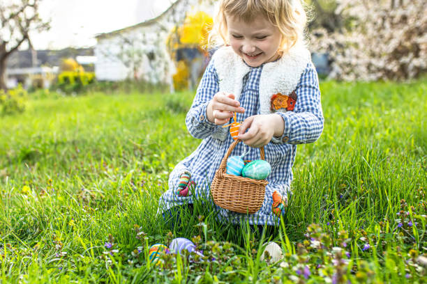 istock little girl with a beaming smile seeks out Easter eggs, 1918090876