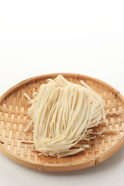 Dried Kwetiaw or Char Kway Teow on Wooden Plates, Isolated on White Background. Chinese Rice Noodle