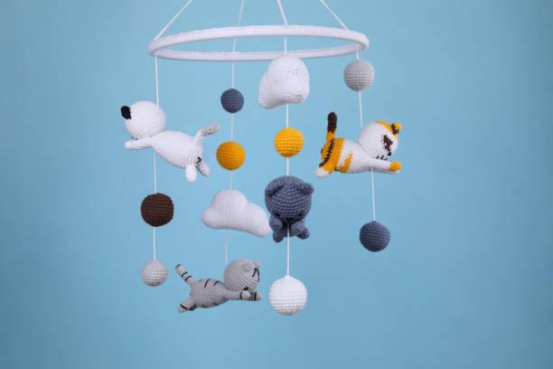 istock Cute baby crib mobile on light blue background 1918093051