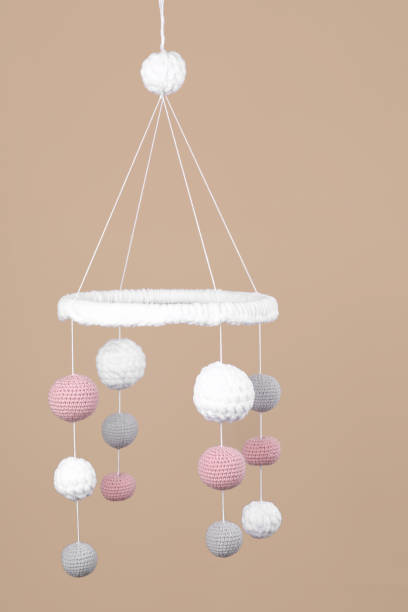 istock Cute baby crib mobile on beige background 1918093055