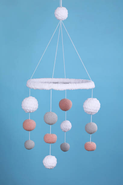 istock Cute baby crib mobile on light blue background 1918093578
