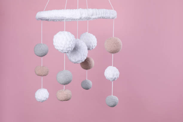 istock Cute baby crib mobile on pink background 1918094105