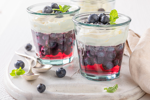 Sweet and creamy jelly with whipped cream and berries. Jelly with berries and whipped cream.