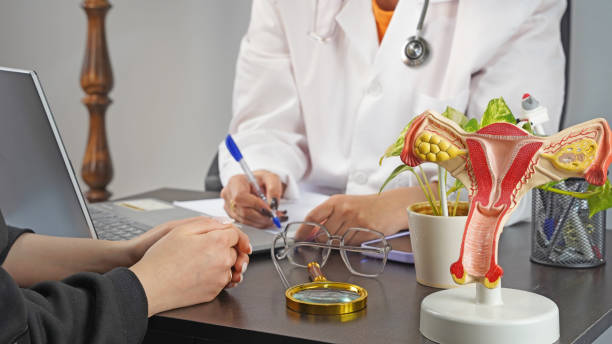 Doctor is writing prescription for patient who has some vaginal issues.