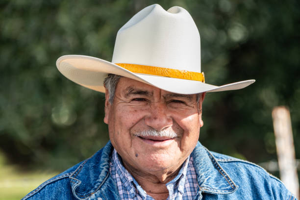 istock Smiling senior Hispanic man looking at camera wearing a cowboy hat 1918109027
