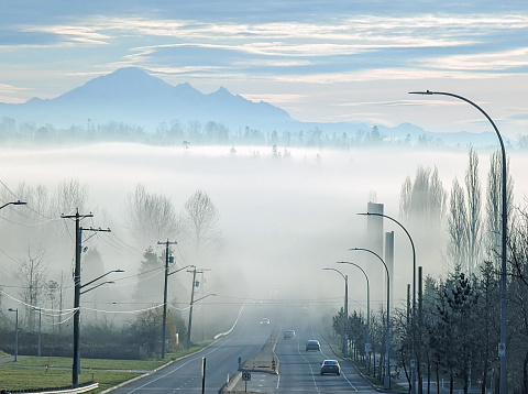 Looking southeast from Fraser Highway at 168th Street to the fog over the Surrey Golf Club. Autumn morning in Metro Vancouver.