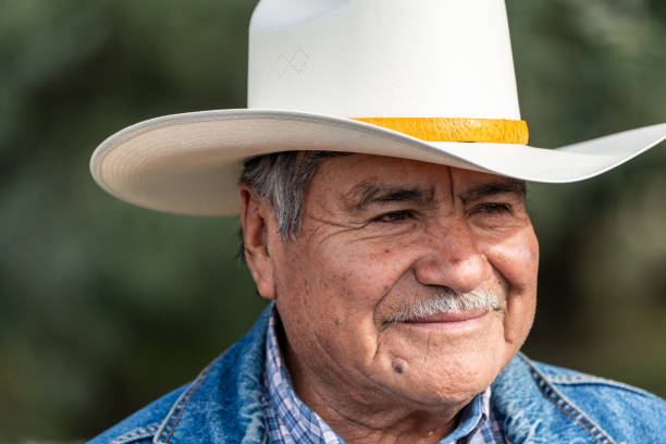istock Smiling senior Hispanic man looking away wearing a cowboy hat 1918109032