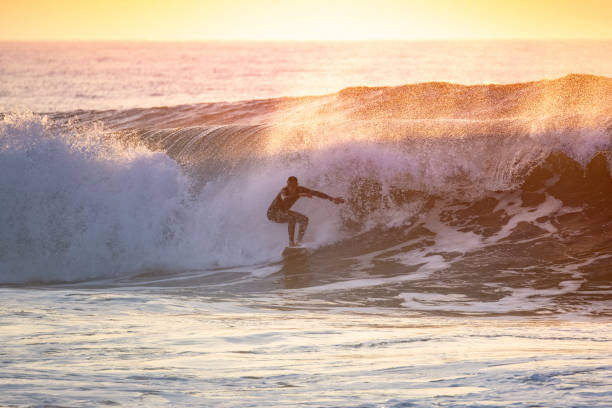 istock Sporty boy riding his surf board 1918117980
