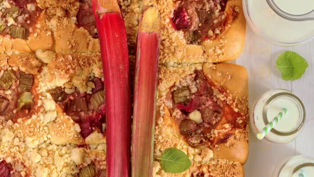 Tasty cake with rhubarb as dessert served with milk.