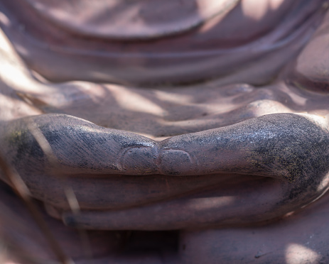 Artistic photo of hands statue Bouddha