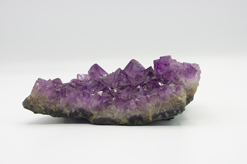 Purple  amethyst crystal on white background