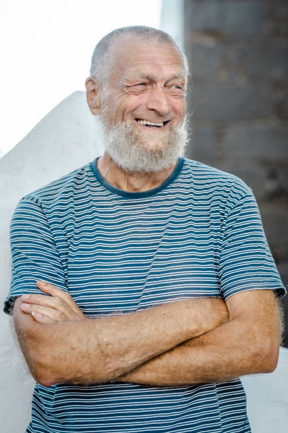 istock 75 year old senior man laughs while having a good time outdoors. 1918223785