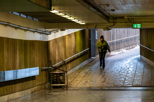 Stockholm, Sweden Dec 27, 2023 A pedestrian enters the Tekniska Hogskolan Metro stop through a tunnel.