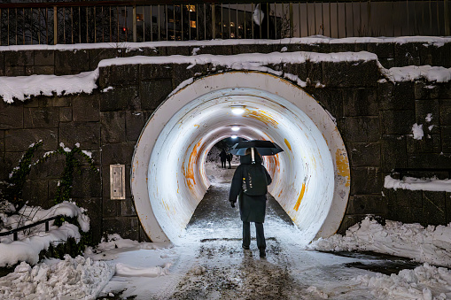 Stockholm, Sweden Dec 29, 2023 Pedestrians walking through a pedestrian tunnel in the Fruangen district in winter.